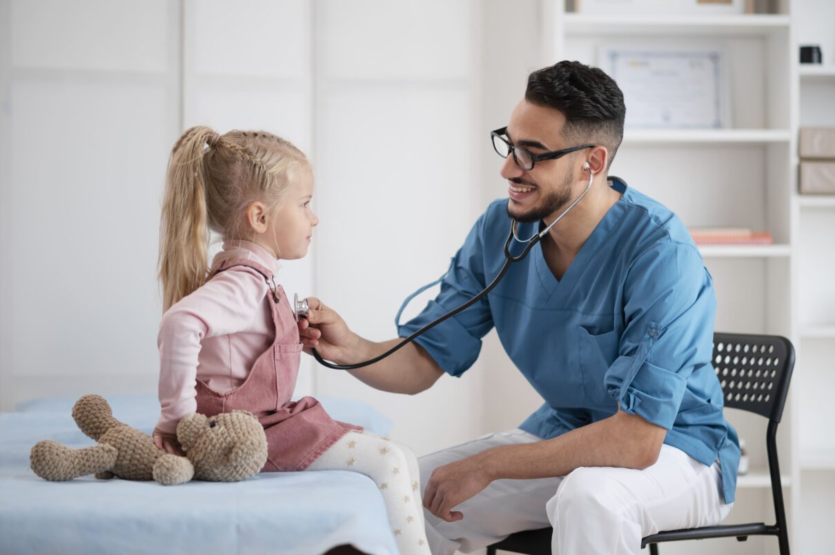 Primary: "Pediatric primary care doctor examining happy child during routine check-up" Secondary: "Child health services including vaccinations and developmental screenings"